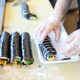 woman making kimbap